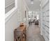 Bright hallway with wood floors, white trim, staircase, decorative window, and entry to living area at 785 52Nd N Ave, St Petersburg, FL 33703