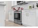 Close-up of modern oven, white cabinets and subway tile backsplash at 785 52Nd N Ave, St Petersburg, FL 33703