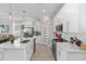 Bright kitchen with center island, stainless steel appliances, modern lighting, and easy access to dining area at 785 52Nd N Ave, St Petersburg, FL 33703