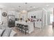 Modern kitchen with white cabinets, subway tile backsplash, stainless steel appliances, and island with seating at 785 52Nd N Ave, St Petersburg, FL 33703