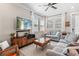 Bright living room features neutral walls, ceiling fan, three windows and comfortable gray furniture at 785 52Nd N Ave, St Petersburg, FL 33703