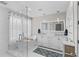 Bright bathroom features a soaking tub, glass shower, and double vanity with marble countertop at 785 52Nd N Ave, St Petersburg, FL 33703