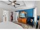 Bright main bedroom with a tray ceiling, blue accent wall, and walk-in closet access at 785 52Nd N Ave, St Petersburg, FL 33703