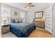 Comfortable bedroom with natural light, wood-look floors, and a blue patterned comforter at 785 52Nd N Ave, St Petersburg, FL 33703