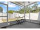 Cozy screened patio with a small table and chairs, overlooking a well-maintained fenced yard at 785 52Nd N Ave, St Petersburg, FL 33703