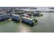 Aerial view of waterfront condos, showcasing bay access, beautifully landscaped grounds, and covered parking at 7922 Sailboat Key S Blvd # 105, South Pasadena, FL 33707
