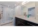 Modern bathroom featuring a glass shower with a bench, contemporary tiling, and a sleek dark vanity at 7922 Sailboat Key S Blvd # 105, South Pasadena, FL 33707