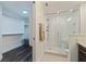 Clean bathroom showcases a glass shower, neutral tiling, and a convenient closet space for storage at 7922 Sailboat Key S Blvd # 105, South Pasadena, FL 33707