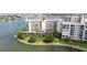 Stunning waterfront condo featuring direct water views, covered parking, and lush tropical landscaping at 7922 Sailboat Key S Blvd # 105, South Pasadena, FL 33707