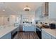 Bright kitchen features stainless appliances, light blue cabinets, and views of the living room and balcony at 7922 Sailboat Key S Blvd # 105, South Pasadena, FL 33707