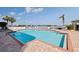 Enjoy the community pool with views of the bay with surrounding palm trees at 7922 Sailboat Key S Blvd # 105, South Pasadena, FL 33707