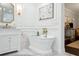 Elegant bathroom featuring soaking tub with gold fixtures, and designer vanity at 805 Bannockburn Ave, Temple Terrace, FL 33617