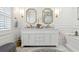 Bright bathroom featuring double vanity, gold fixtures, marble counters and floors, and tub at 805 Bannockburn Ave, Temple Terrace, FL 33617