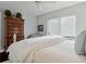Bedroom featuring a neutral color palette, ceiling fan, and a large chest of drawers at 805 Bannockburn Ave, Temple Terrace, FL 33617