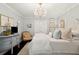 Bright bedroom featuring a chandelier, dresser, and a comfortable sitting chair at 805 Bannockburn Ave, Temple Terrace, FL 33617