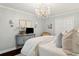 Charming bedroom with a chandelier, a gray dresser, and soft neutral colors at 805 Bannockburn Ave, Temple Terrace, FL 33617
