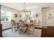 Traditional dining room with a wooden table, upholstered chairs, chandelier, and large window at 805 Bannockburn Ave, Temple Terrace, FL 33617