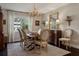 Traditional dining room with a wood table, chandelier, area rug, and window at 805 Bannockburn Ave, Temple Terrace, FL 33617