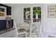 Cozy dining room features a round table, floral chairs, and French doors at 805 Bannockburn Ave, Temple Terrace, FL 33617