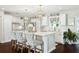 Stylish kitchen with white cabinets, marble countertops, pendant lights, and a center island with seating at 805 Bannockburn Ave, Temple Terrace, FL 33617