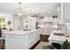 Bright kitchen featuring white cabinetry, marble countertops, stainless appliances and an island with pendant lighting at 805 Bannockburn Ave, Temple Terrace, FL 33617