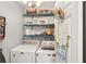 Bright laundry room with open shelving and floral accents, with washer and dryer at 805 Bannockburn Ave, Temple Terrace, FL 33617