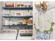 Bright laundry room featuring washer and dryer, open shelves, and botanical accents at 805 Bannockburn Ave, Temple Terrace, FL 33617