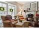 Cozy living room with natural light and comfortable seating near a fireplace and french doors at 805 Bannockburn Ave, Temple Terrace, FL 33617