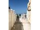 Private beach access with white picket fences and sandy path to the ocean at 8565 W Gulf Blvd # 21S, St Petersburg, FL 33706