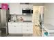 Modern kitchen featuring white cabinets, stainless steel appliances, and granite countertops at 8565 W Gulf Blvd # 21S, St Petersburg, FL 33706