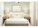 This staged bedroom boasts a queen bed, neutral color palette and natural light at 8636 Linked Dr, New Port Richey, FL 34655