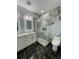Stylish bathroom with a glass shower enclosure, double sink vanity, and luxurious marble-look accents at 907 E Okaloosa Ave, Tampa, FL 33604