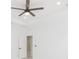 Bedroom featuring clean white walls, modern ceiling fan, tile flooring, and bright natural light at 907 E Okaloosa Ave, Tampa, FL 33604