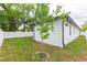 Well-maintained backyard with white fence and lush green grass, complementing the home's clean and modern exterior at 907 E Okaloosa Ave, Tampa, FL 33604