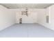 Clean and spacious garage with a finished floor, overhead storage, and ample room for parking and projects at 907 E Okaloosa Ave, Tampa, FL 33604