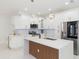 Modern kitchen with an island, stainless steel appliances, and pendant lighting at 907 E Okaloosa Ave, Tampa, FL 33604