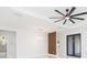 Bright living room featuring white walls, tile floors, modern lighting, and stylish wood accent wall at 907 E Okaloosa Ave, Tampa, FL 33604