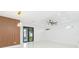 Bright living room featuring sleek wood wall decor, a modern ceiling fan, and recessed lighting at 907 E Okaloosa Ave, Tampa, FL 33604