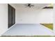 A covered patio features a ceiling fan, offering a serene outdoor space for relaxation and entertainment at 907 E Okaloosa Ave, Tampa, FL 33604