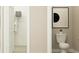 Bright half bath featuring a modern toilet and framed print, along with ample storage space in the attached closet at 9582 Runaway Breeze Dr, Land O Lakes, FL 34637