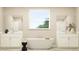 Elegant bathroom features a soaking tub, double vanities, and modern fixtures, creating a spa-like atmosphere at 9582 Runaway Breeze Dr, Land O Lakes, FL 34637
