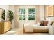Bright bedroom with a large window, stylish furniture, and a calming color palette at 9582 Runaway Breeze Dr, Land O Lakes, FL 34637
