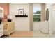 Cozy Bedroom featuring a crib, dresser, and a comforting neutral color palette with a touch of peach at 9582 Runaway Breeze Dr, Land O Lakes, FL 34637