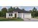 Charming single-story home with a two-car garage and beautifully landscaped front yard at 9582 Runaway Breeze Dr, Land O Lakes, FL 34637