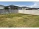 Large fenced backyard featuring a lawn and outdoor seating at 9616 Lemon Drop Loop, Sun City Center, FL 33573