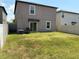 Fenced backyard featuring a well-maintained lawn, sliding door, and grill at 9616 Lemon Drop Loop, Sun City Center, FL 33573