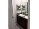 Modern bathroom featuring double sinks, granite countertops, and stylish shelving at 9616 Lemon Drop Loop, Sun City Center, FL 33573
