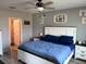 Bright bedroom featuring a large bed, bedside tables, and decorative wall art at 9616 Lemon Drop Loop, Sun City Center, FL 33573