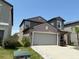 Two-story home showcasing neutral color palette, well maintained lawn, and a two car garage at 9616 Lemon Drop Loop, Sun City Center, FL 33573