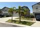 Two-story home showcasing palm trees, front lawn, and a two car garage at 9616 Lemon Drop Loop, Sun City Center, FL 33573